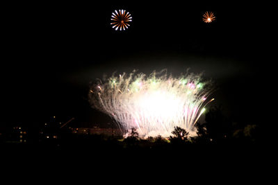 Low angle view of firework display at night