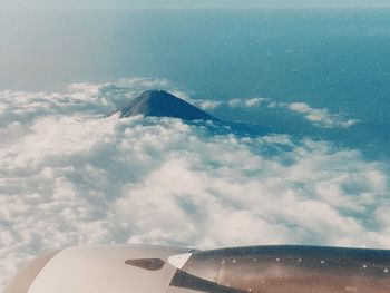 Aerial view of cloudscape over airplane wing