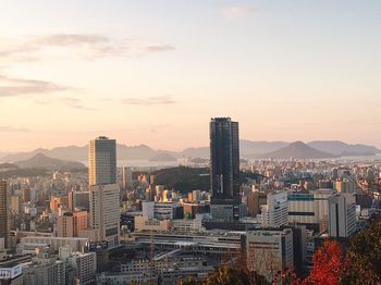 High angle view of buildings in city against sky during sunset