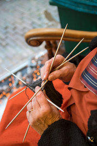 Midsection of woman knitting wool