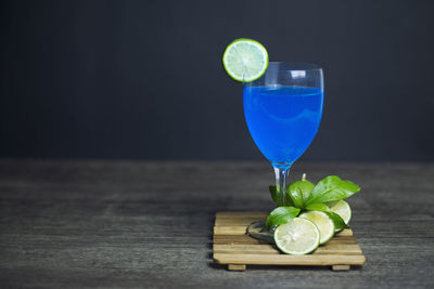 Green fruits in glass on table