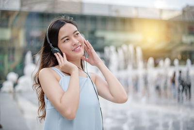 Portrait of a smiling young woman in city