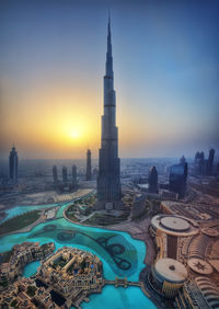 Aerial view of modern buildings against sky during sunset