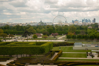 Park in city against cloudy sky