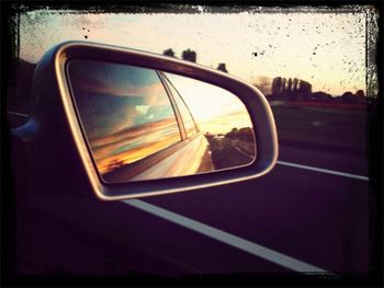 Reflection of car on road at sunset