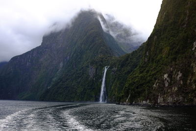 Scenic view of waterfall amidst mountains