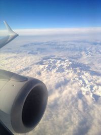 Cropped image of airplane flying over sea