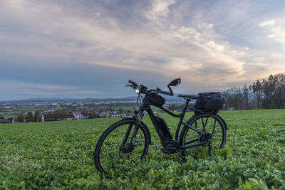 Bicycle on field against sky