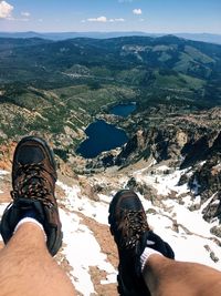 Low section of man with mountains in background