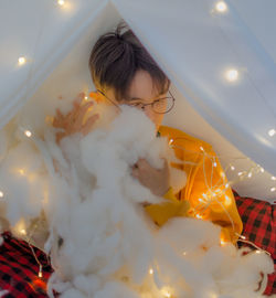 Portrait of boy looking at illuminated christmas lights