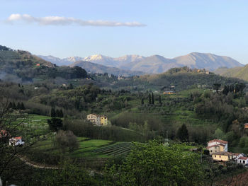 Scenic view of landscape and houses against sky