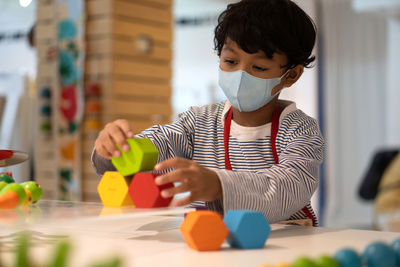 Boy playing with toy at home