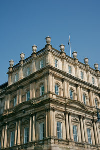 Low angle view of building against blue sky