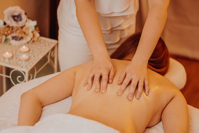 Midsection of woman massaging customer