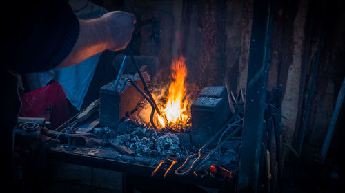 Close-up of man working on barbecue grill