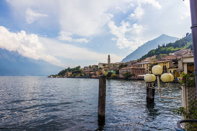 Scenic view of sea by buildings against sky