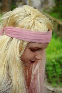 Close-up of girl wearing wig while sitting outdoors