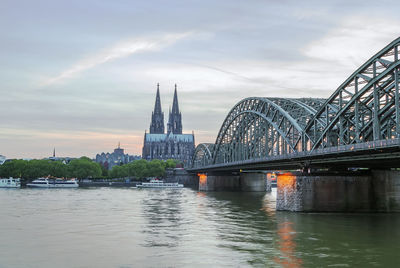 Bridge over river with city in background