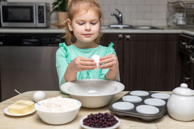 Portrait of boy eating food at home