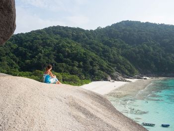 Woman sitting on mountain at similan islands