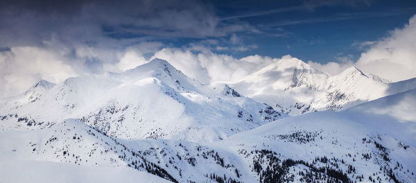 Scenic view of snowcapped mountains against sky