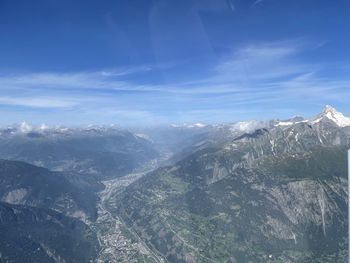 Aerial view of snowcapped mountains against sky