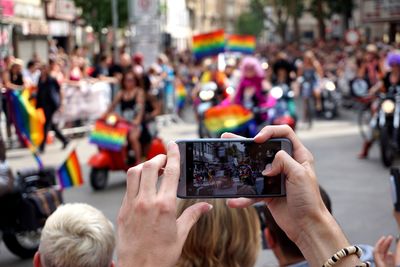 People photographing on street in city