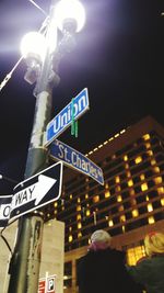 Low angle view of information sign at night