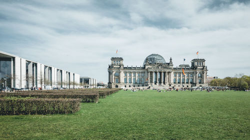 Reichstag building against cloudy sky