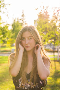 Portrait of beautiful young woman against plants