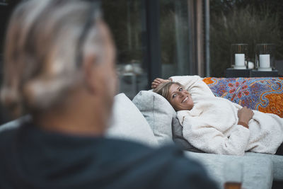 Rear view of couple relaxing outdoors