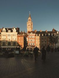 Walking in an old city with sunset above us