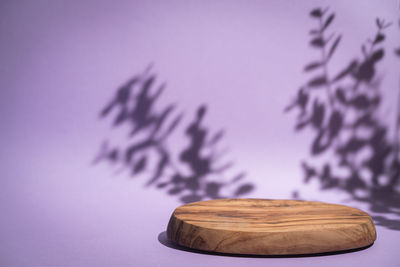 Close up of wooden board against purple background