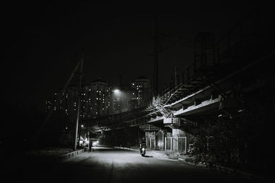 Illuminated bridge in city at night