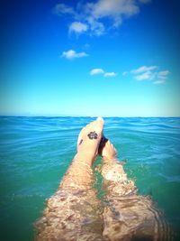 Low section of woman swimming in sea