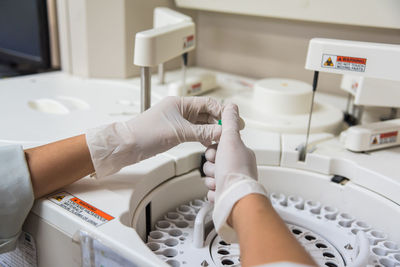 Cropped hands of doctor working at laboratory