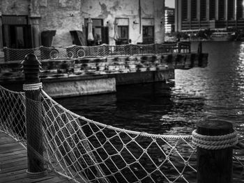 Close-up of fence on pier over sea