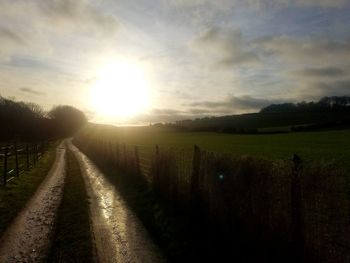 Scenic view of field against sky during sunset