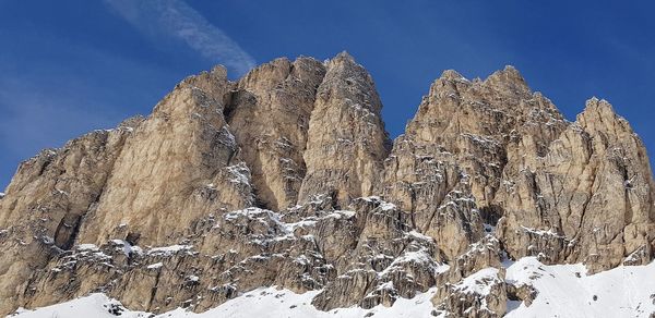 Low angle view of snowcapped mountain against sky