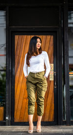 Portrait of young woman standing outdoors