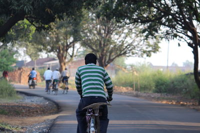 Rear view of woman walking on footpath