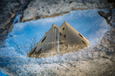 Low angle view of text on snow covered land against sky