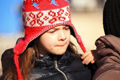 Close-up portrait of cute girl wearing hat during winter