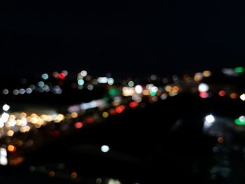 Defocused image of illuminated city street at night