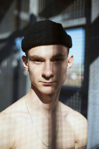 Portrait of shirtless young man wearing hat