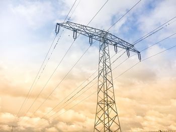 Low angle view of electricity pylon against sky