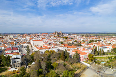 Evora drone aerial view on a sunny day with historic buildings city center in alentejo, portugal