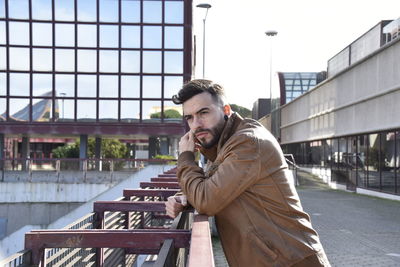 Portrait of young man in city