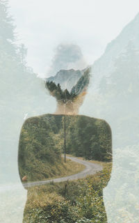 Rear view of man on glass window against sky