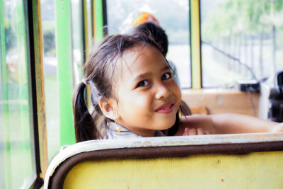 Portrait of smiling girl sitting in bus